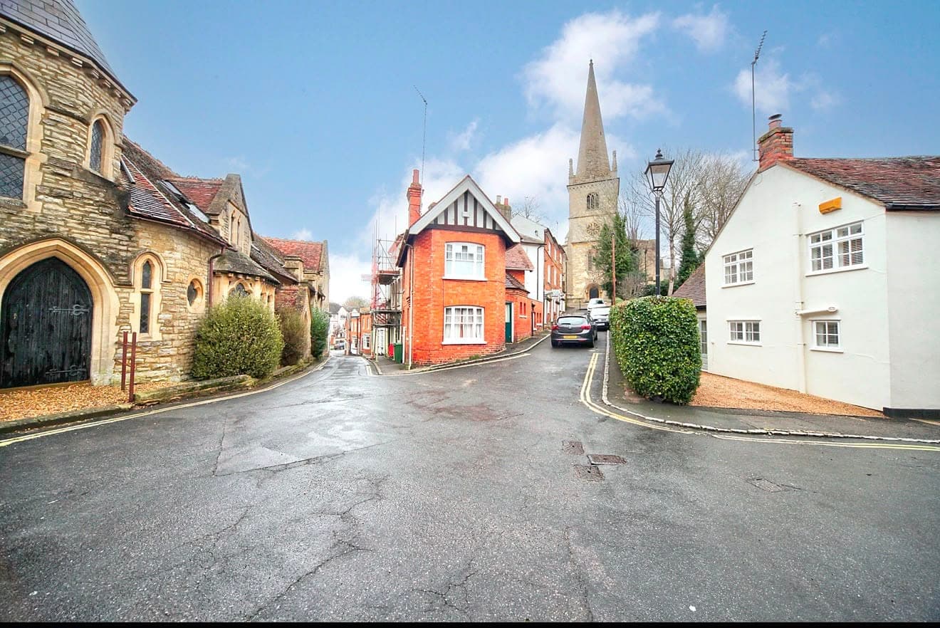 Historic Buckingham town centre with the parish church spire and period cottages