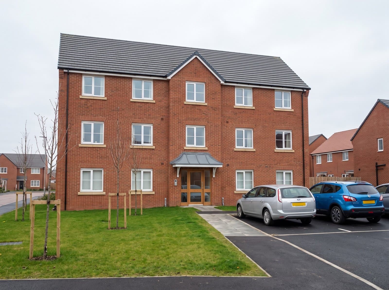 Modern British new-build block of flats with communal entrance and parking Modern British new-build block of flats with communal entrance and parking