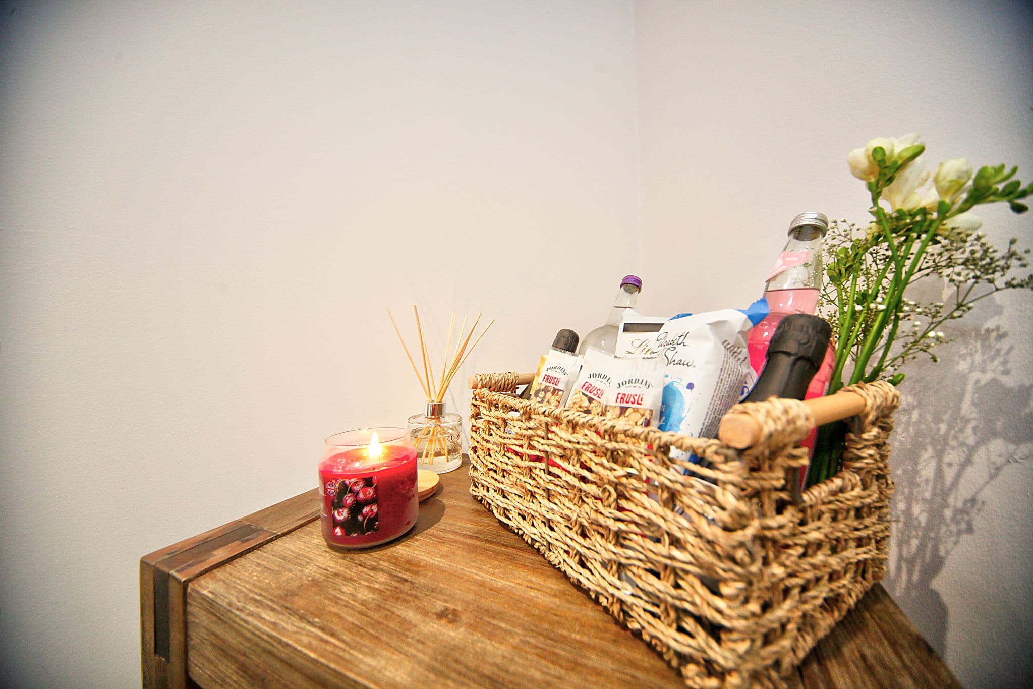 Welcome basket, candle and fresh flowers prepared for guests arriving at a LinkStays apartment Welcome basket, candle and fresh flowers prepared for guests arriving at a LinkStays apartment